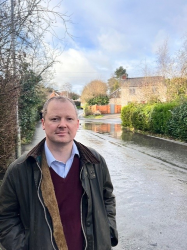 Neil at the site of flooding in Great Glen